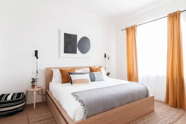 a bedroom with a bed and a window