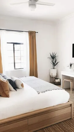 a bedroom with a bed and window
