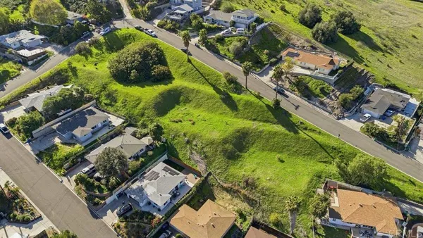 an aerial view of residential houses with outdoor space