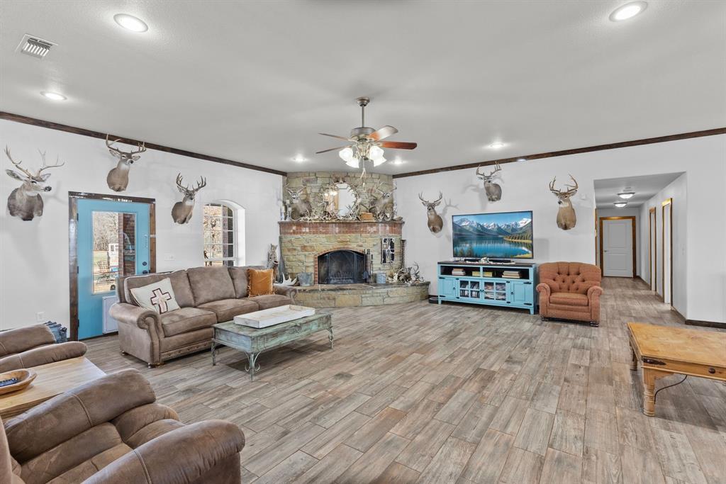 24 County Rd NW 1060 Talco, TX 75487 - Photo 6 of 40 a living room with furniture a fireplace and a chandelier