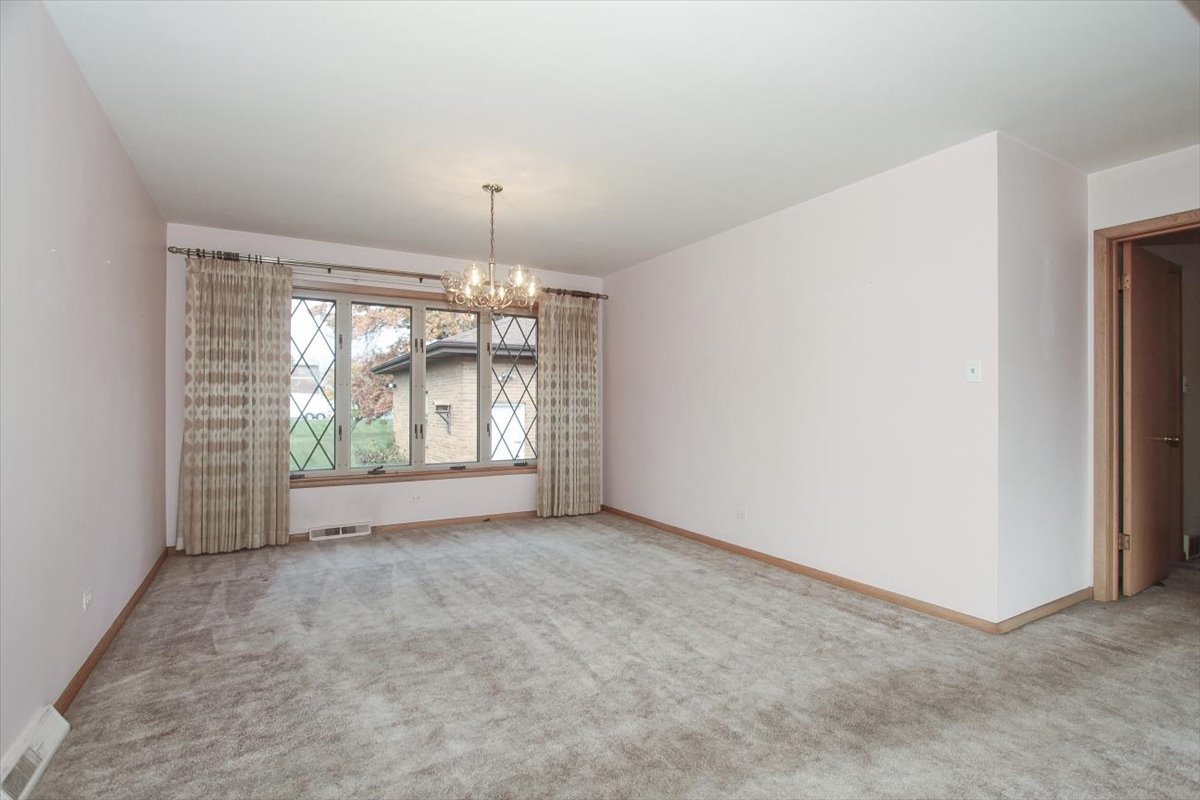 1420 Indian Hill Drive Schaumburg, IL 60193 - Photo 13 of 33 a view of an empty room with window and chandelier fan