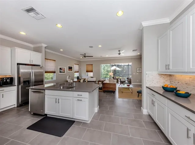 a kitchen with sink cabinets and stainless steel appliances