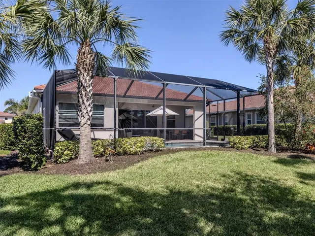 a view of a house with a yard and sitting area