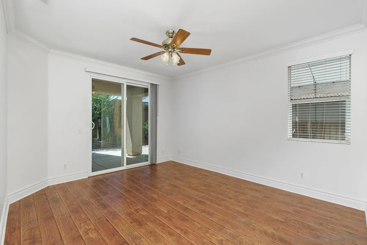 1132 Tabernacle Lane San Jacinto, CA 92582 - Photo 14 of 39 a view of empty room with wooden floor and fan