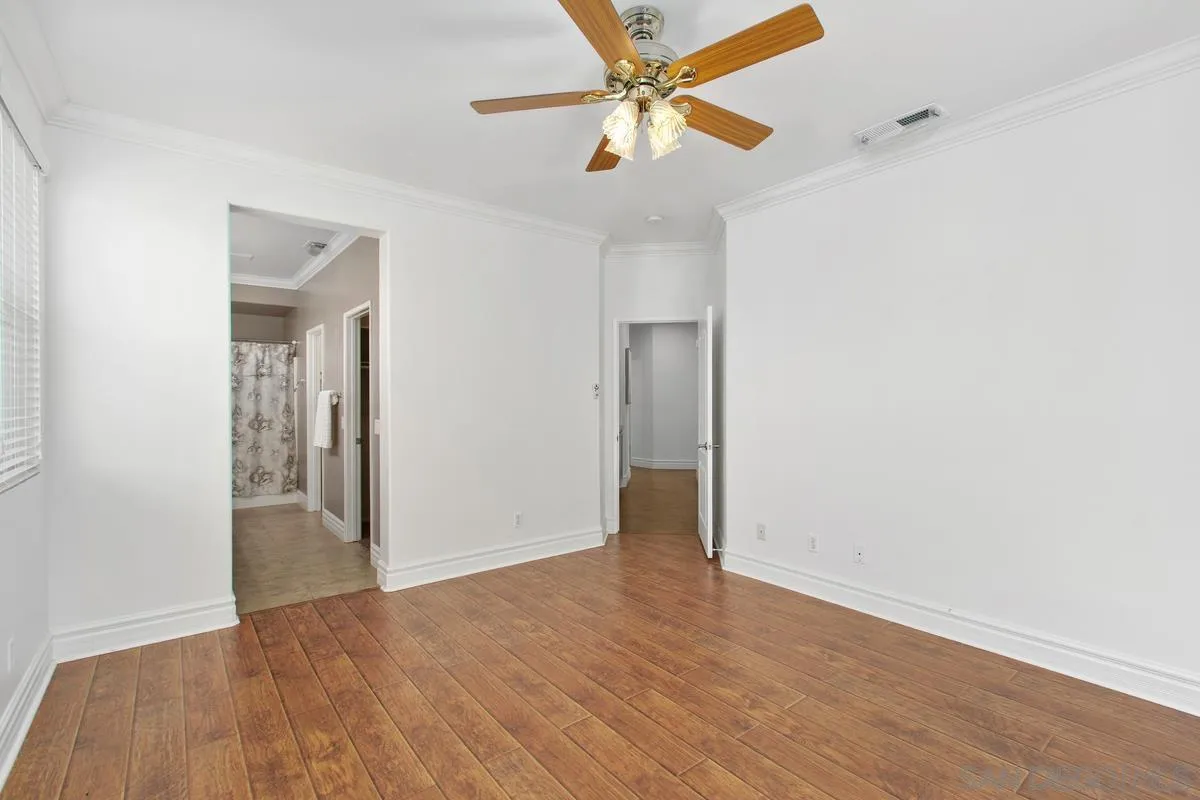 1132 Tabernacle Lane San Jacinto, CA 92582 - Photo 19 of 39 an empty room with wooden floor closet and a ceiling fan
