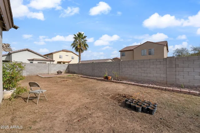 a backyard of a house with table and chairs