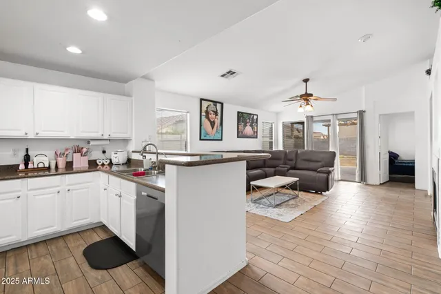 a open kitchen with cabinets and stainless steel appliances