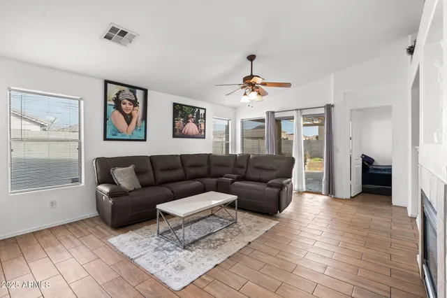 a living room with furniture and a ceiling fan