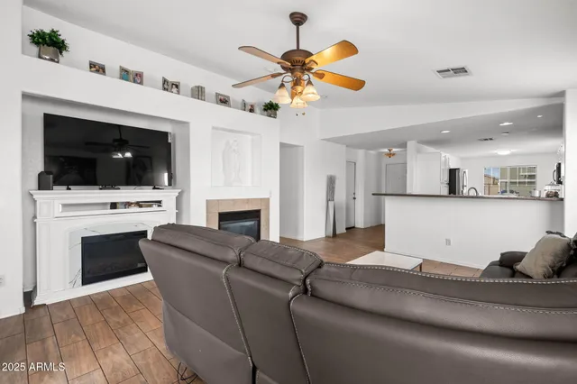 a living room with furniture a fireplace and a flat screen tv