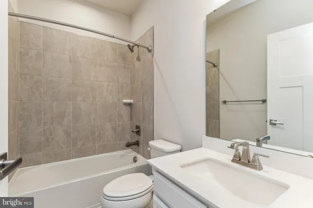 a bathroom with a sink a toilet and a bathtub