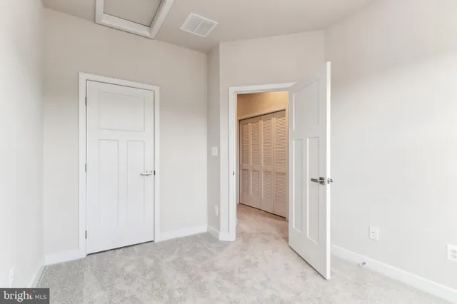 a view of an empty room and closet area