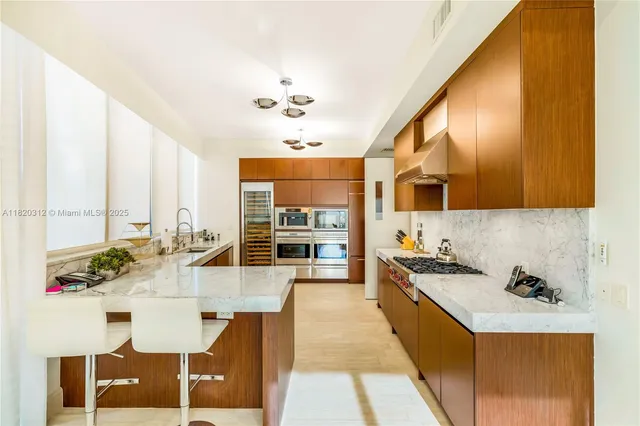 a large kitchen with a table and chairs