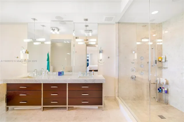 a bathroom with a sink vanity granite shower and a mirror