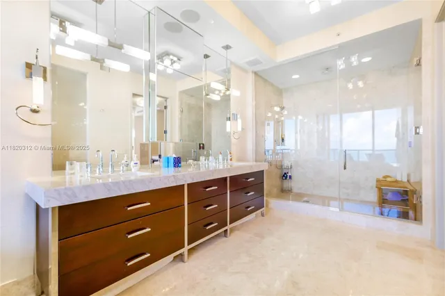 a spacious bathroom with a granite countertop sink mirror and a bathtub
