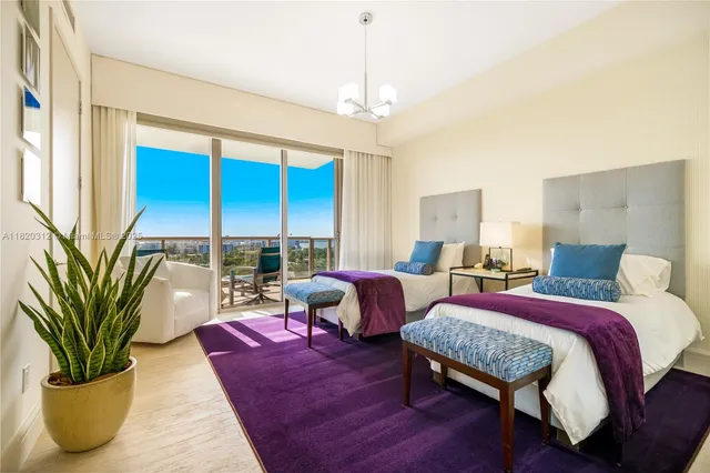 a bedroom with furniture and a large window