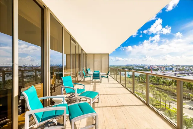 a balcony with chairs and city view