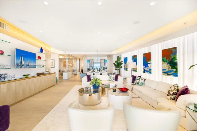 a living room with furniture and kitchen view