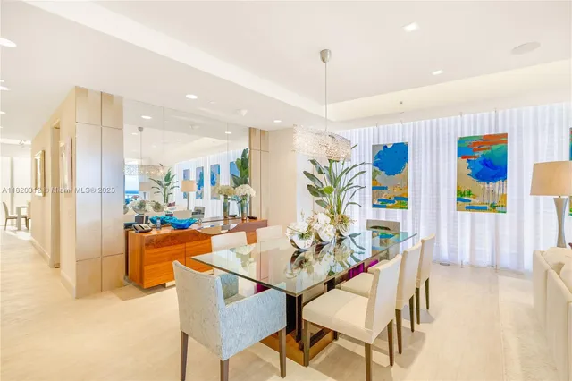 a dining room with furniture and a floor to ceiling window