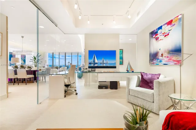 a living room with furniture and a kitchen view