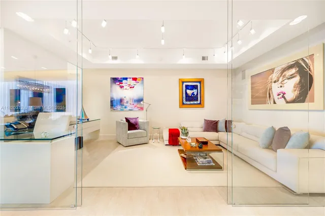 a living room with furniture and kitchen view