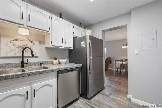 a kitchen with stainless steel appliances granite countertop a refrigerator and a sink