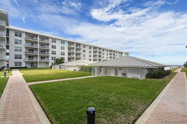 a view of house with a yard
