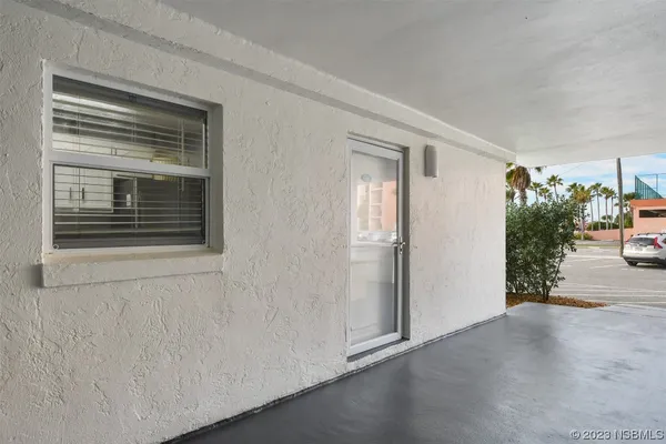 a view of a hallway with wooden floor and a window