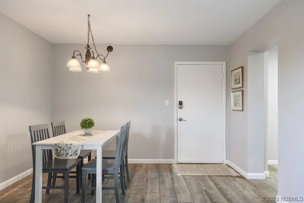 a view of a dining room with a table and chairs