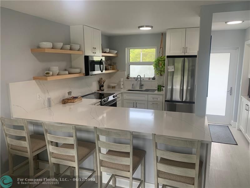 a kitchen with stainless steel appliances a microwave a stove and refrigerator