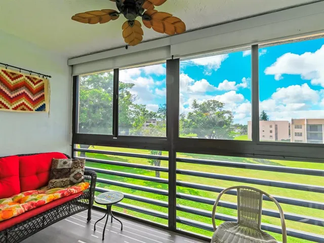 a living room filled with furniture and a floor to ceiling window