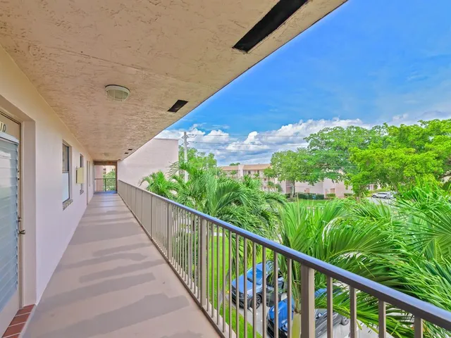 a view of a balcony with flower plants