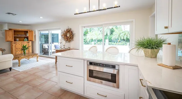 a kitchen with a white stove top oven and white cabinets