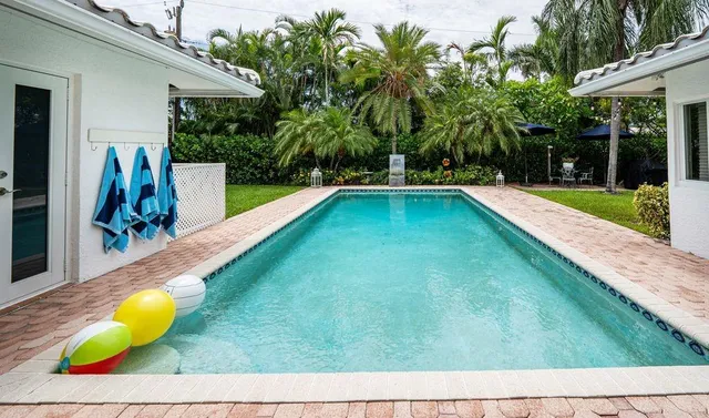 a view of swimming pool with a lounge chairs