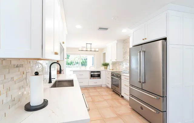 a kitchen with a refrigerator and a sink