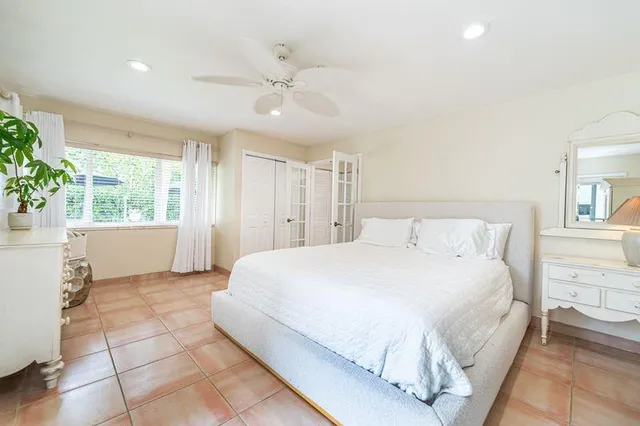 a bedroom with a large bed and a window