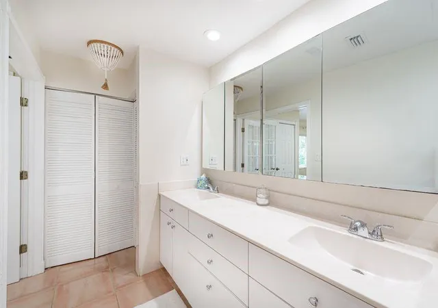 a bathroom with a double vanity sink mirror and double
