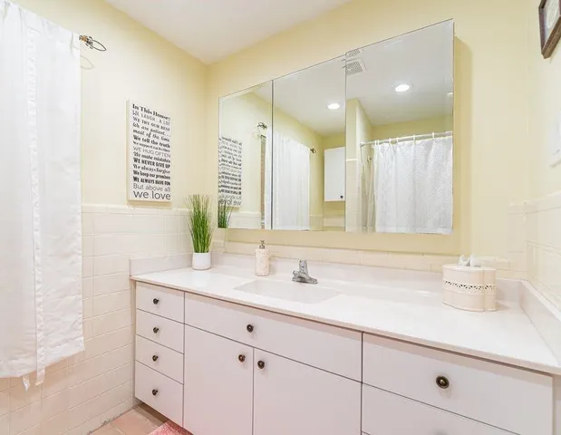 a bathroom with a sink double vanity and a mirror