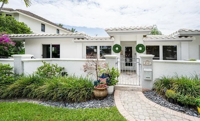 a front view of a house with a garden