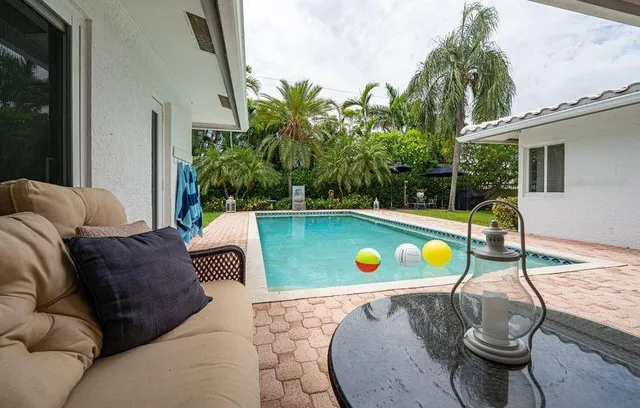 a view of a swimming pool with a patio and yard
