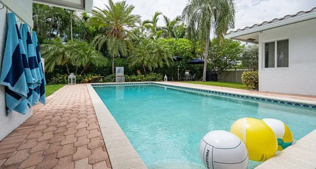 a view of a backyard with swimming pool