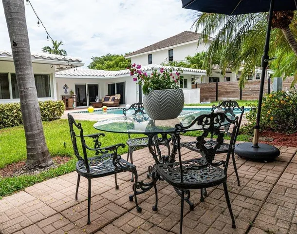 a view of a house with backyard sitting area and furniture