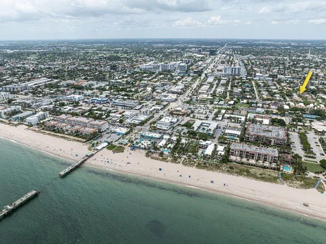 a view of backyard with seating space barbeque oven and trees