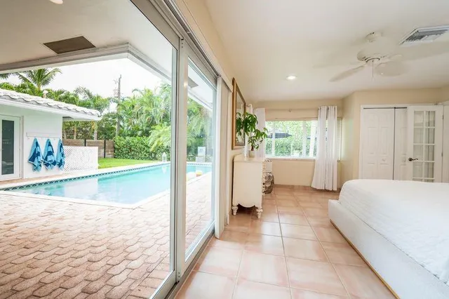 a spacious bedroom with a large window and a bed