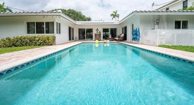 a front view of a house with a yard table and chairs