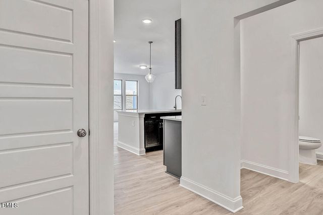 a view of a hallway with a kitchen space