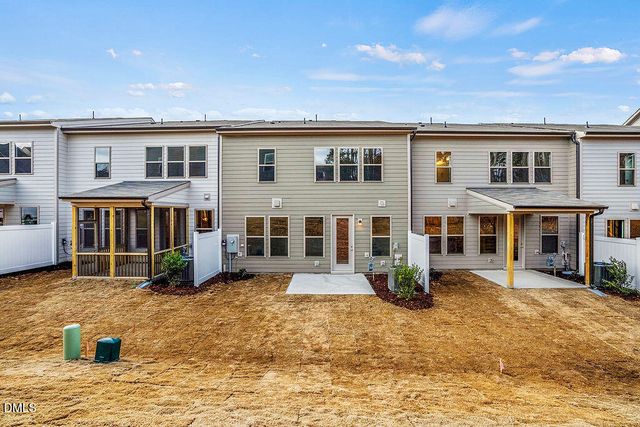 a front view of a house with barbeque sitting area