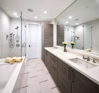 a bathroom with a double vanity sink shower and a mirror
