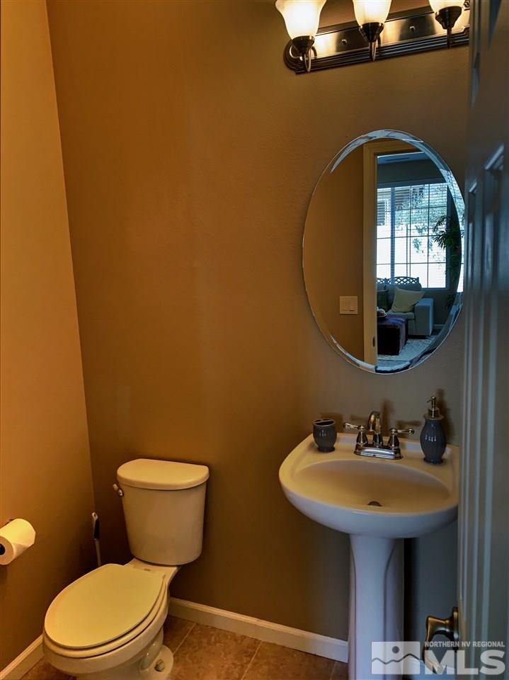 11052 Lamour Lane Reno, NV 89521 - Photo 12 of 23 a bathroom with a toilet sink and mirror