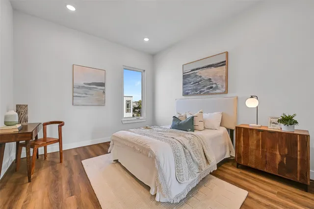 a bedroom with a large bed and a desk