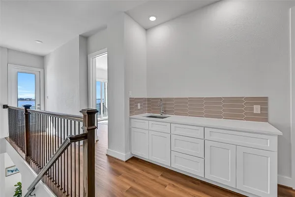 a view of a hallway view with wooden floor and staircase